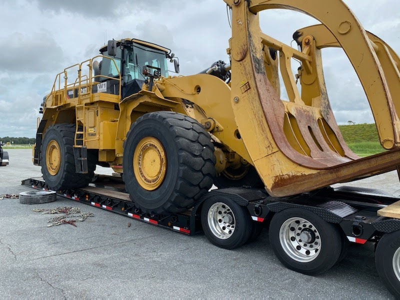 Heavy construction equipment being delivered to an active project