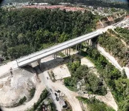Completed bridge spanning a green valley