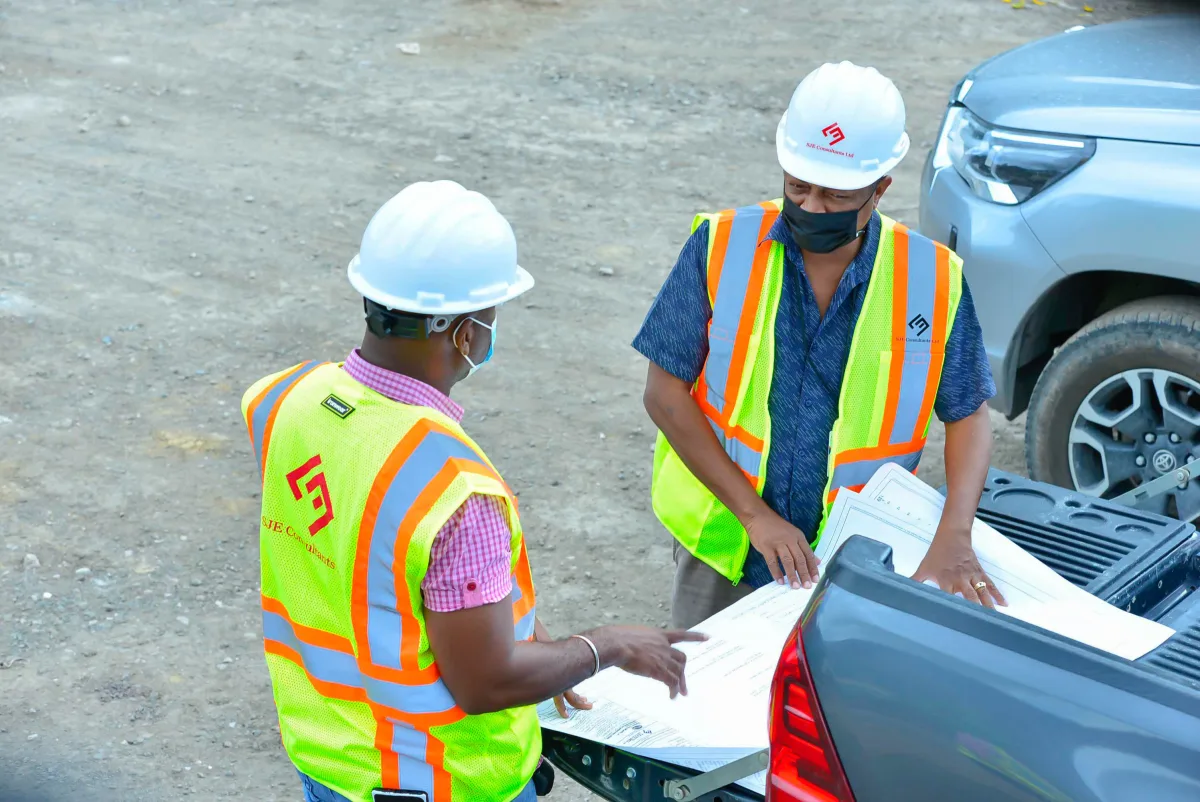 SJE professionals reviewing project plans in the field